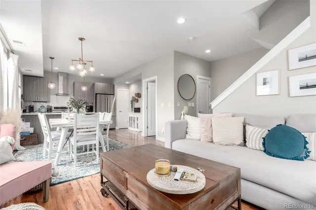a living room with furniture and kitchen view