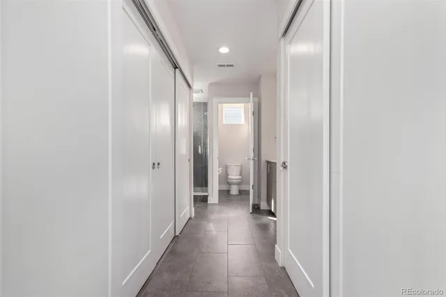 a view of hallway with bathroom