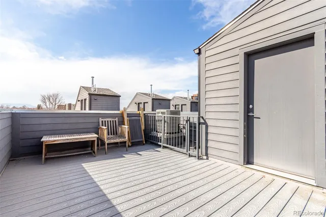 a view of a balcony with wooden floor and seating space