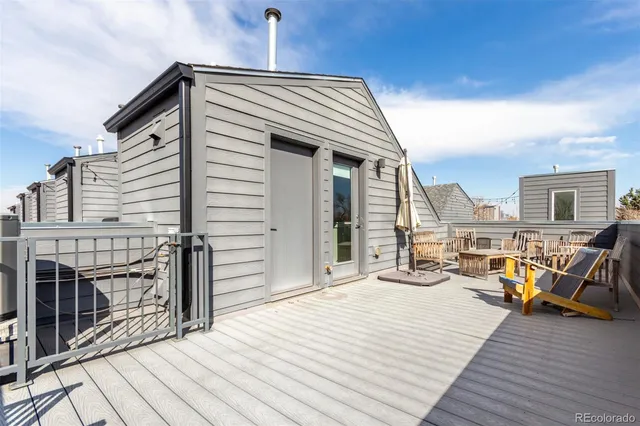 a view of a balcony with two chairs and wooden floor