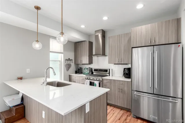 a kitchen with kitchen island a sink stainless steel appliances and cabinets