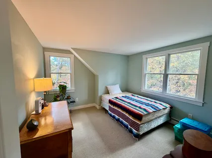 a bedroom with a bed and window