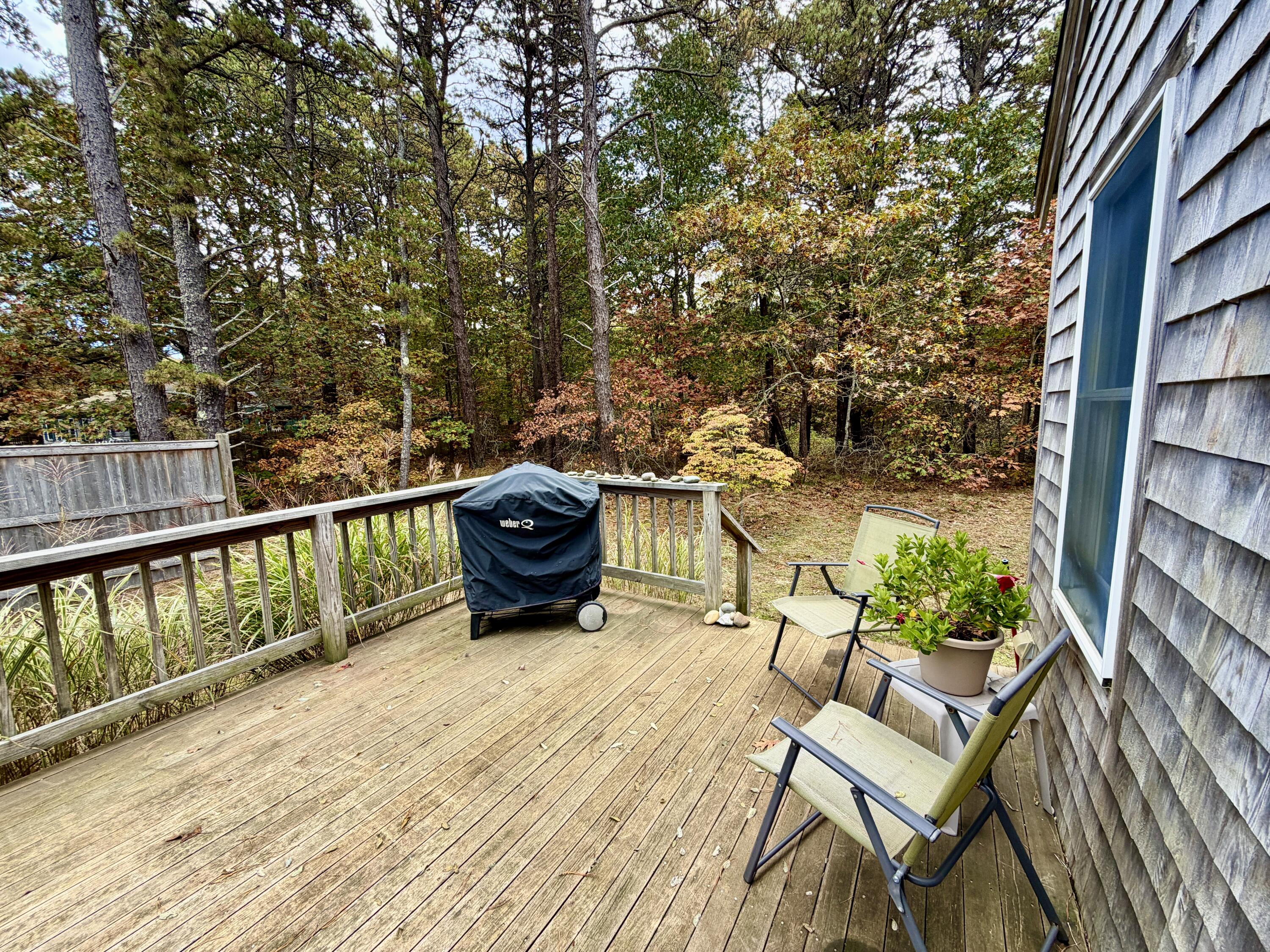 46 Spring Brook Road Wellfleet, MA 02667 - Photo 23 of 37 a roof deck with table and chairs and wooden floor