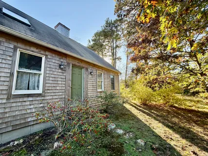 a view of house with backyard