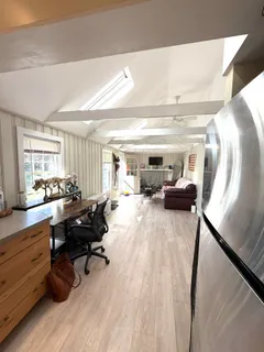 a bedroom with a bed window and mirror