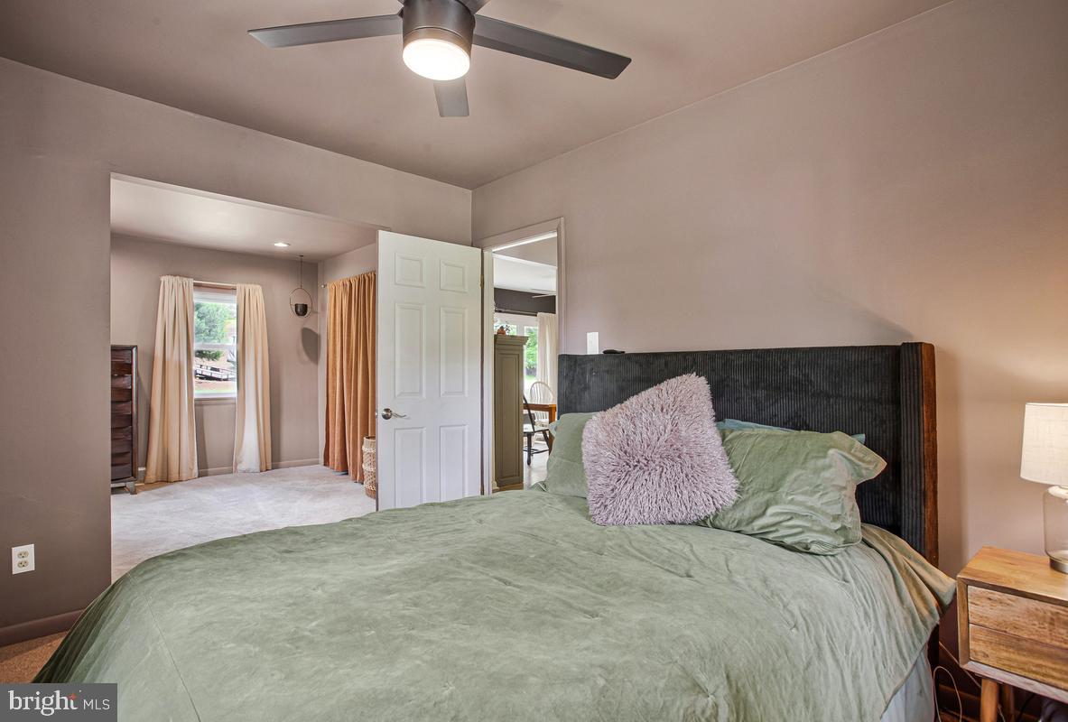 976 Shore Acres Road Arnold, MD 21012 - Photo 24 of 40 a bedroom with a large bed and a chandelier