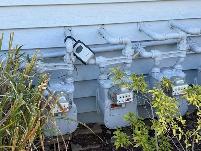 a table with wine vase and flowers on it