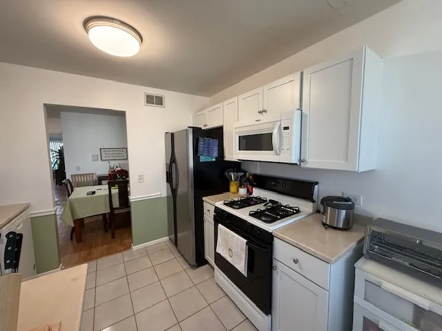 a kitchen with cabinets and appliances