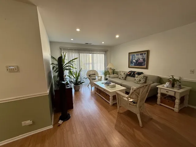 a living room with furniture window and wooden floor
