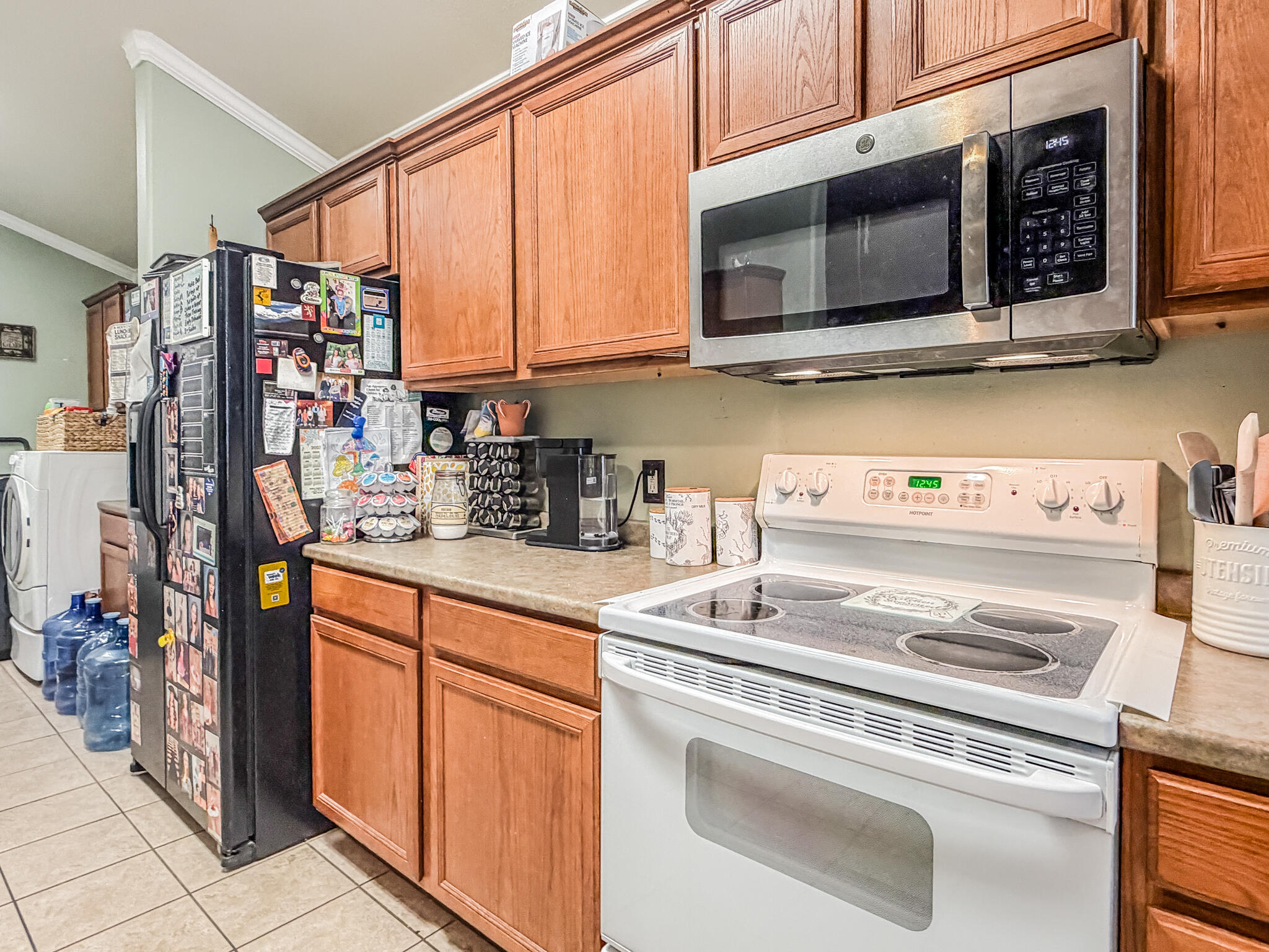 6715 91st Place Lubbock, TX 79424 - Photo 19 of 48 a kitchen with stainless steel appliances granite countertop a stove microwave and cabinets