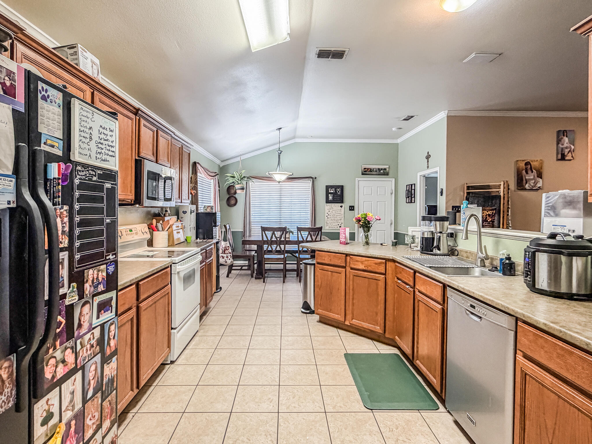 6715 91st Place Lubbock, TX 79424 - Photo 23 of 48 a kitchen with stainless steel appliances granite countertop lots of counter top space and cabinets