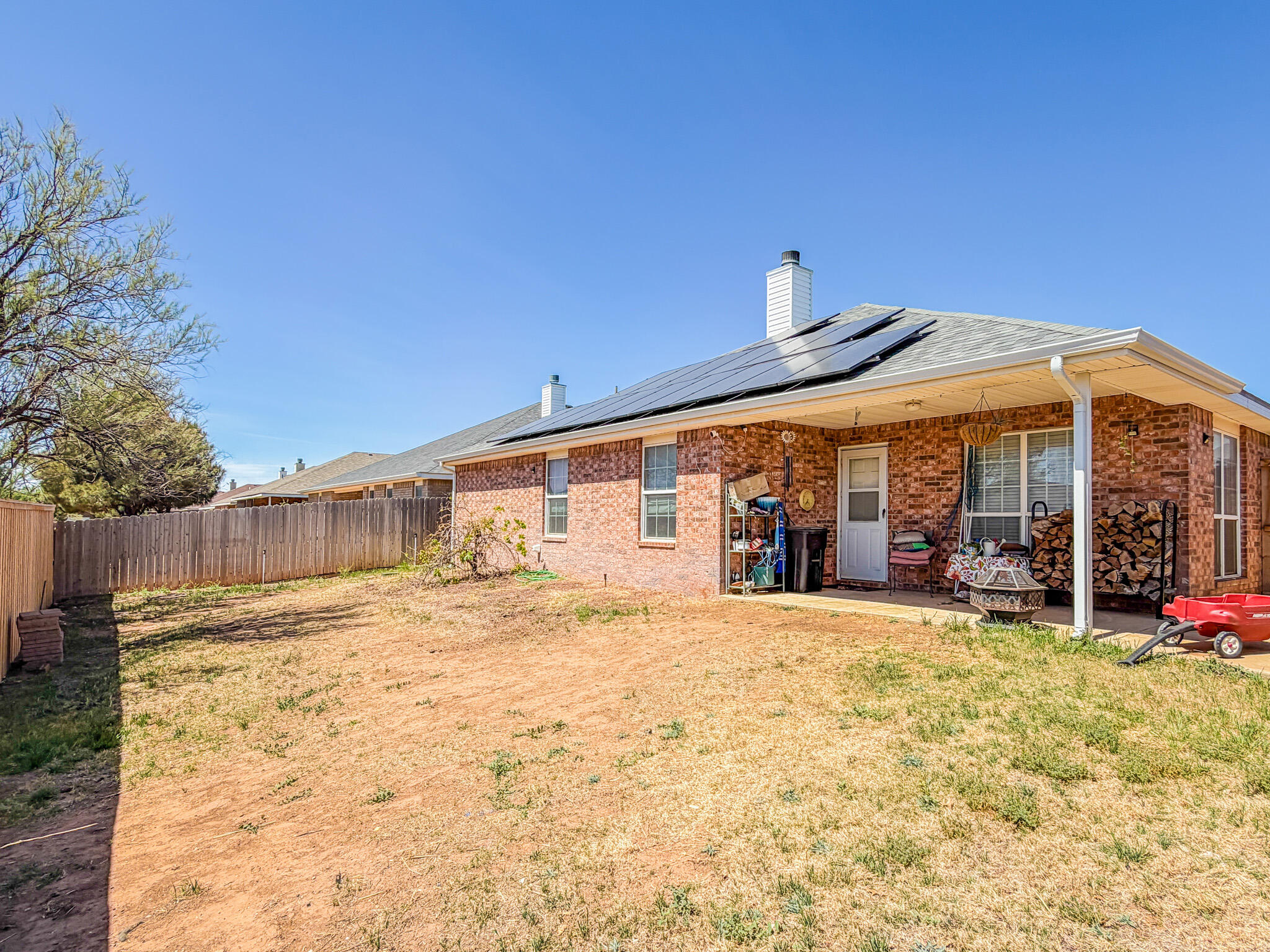 6715 91st Place Lubbock, TX 79424 - Photo 47 of 48 a view of a house with floor to ceiling windows and a basket ball poll