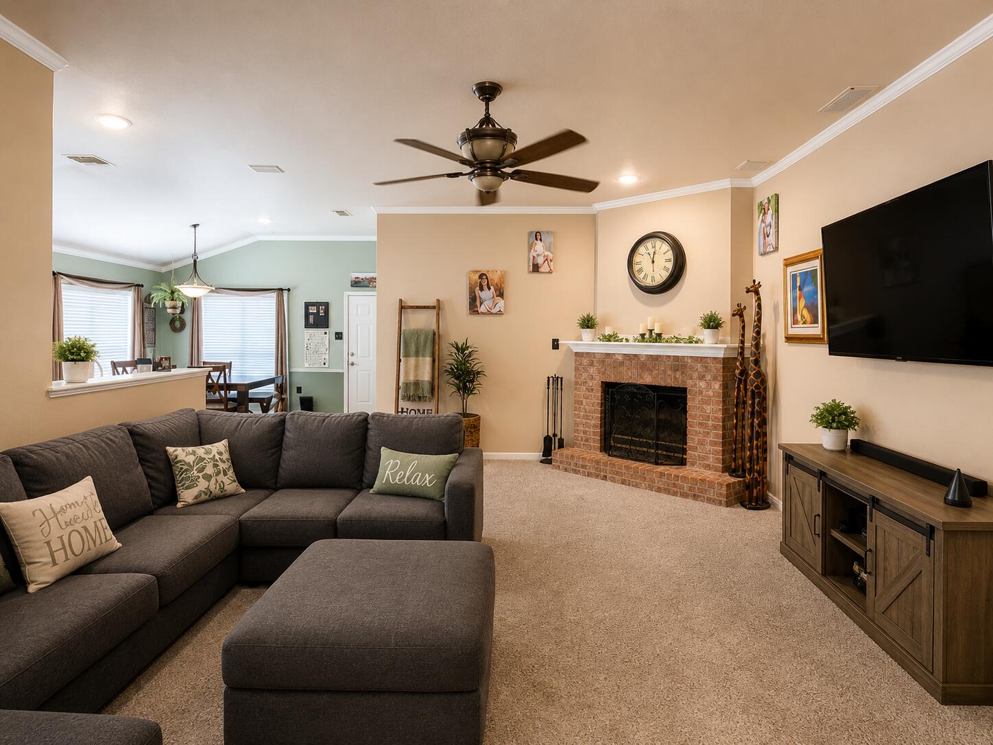6715 91st Place Lubbock, TX 79424 - Photo 6 of 48 a living room with furniture a flat screen tv and a fireplace