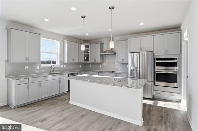 a kitchen with stainless steel appliances granite countertop a sink stove and cabinets