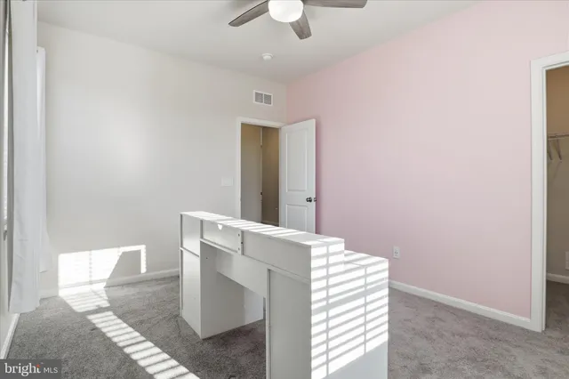 a bathroom with a toilet a sink a mirror a bathtub and vanity