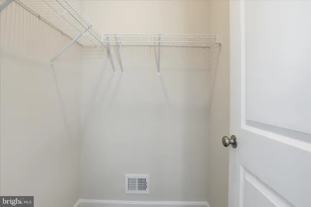 a living room with furniture and a air conditioner vent