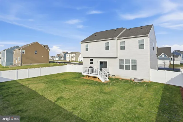 a view of a large house with a big yard and large trees