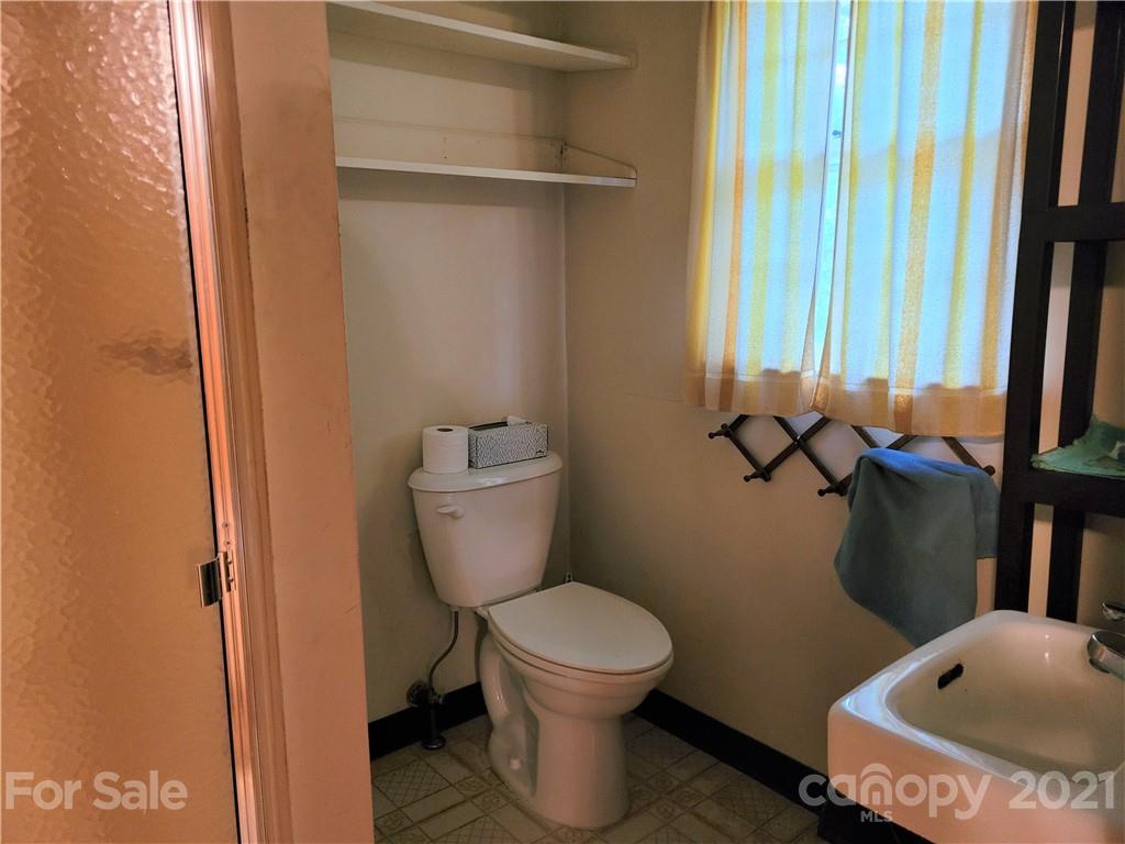 511 Flynn Road Rutherfordton, NC 28139 - Photo 12 of 32 a bathroom with a toilet and a rug