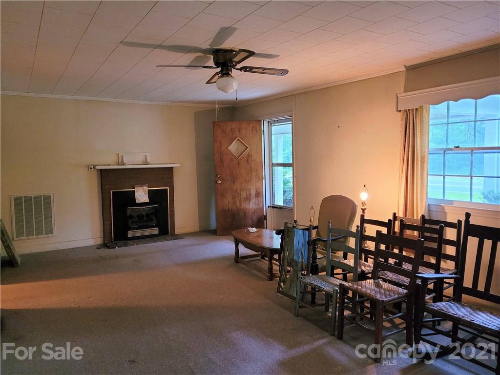 511 Flynn Road Rutherfordton, NC 28139 - Photo 5 of 32 a living room with furniture a fireplace and a window