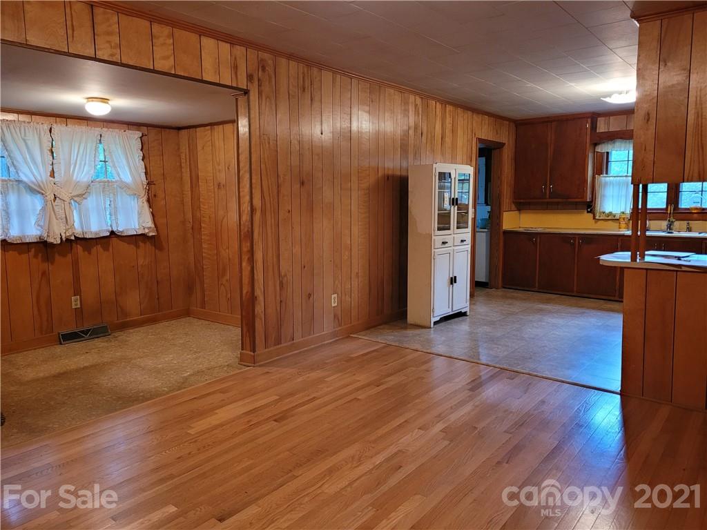 511 Flynn Road Rutherfordton, NC 28139 - Photo 6 of 32 a view of a refrigerator in kitchen and wooden floor