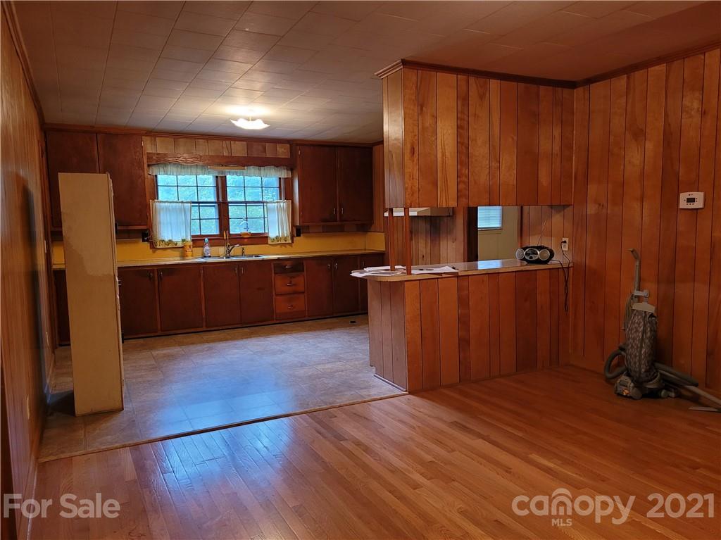 511 Flynn Road Rutherfordton, NC 28139 - Photo 7 of 32 a open kitchen with wooden floor and a sink