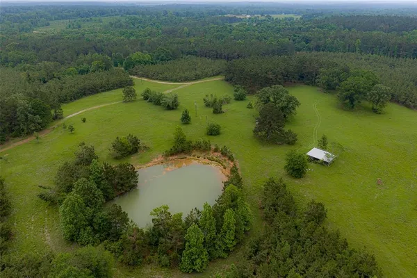 an aerial view of a house with pool outdoor seating yard and green space