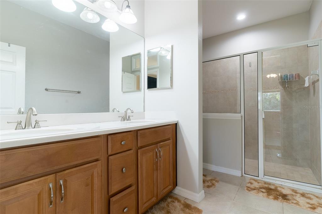 2739 Rutledge Court Winter Haven, FL 33884 - Photo 11 of 24 a bathroom with a double vanity sink mirror and shower