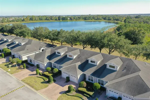 aerial view of a house with outdoor space and lake view