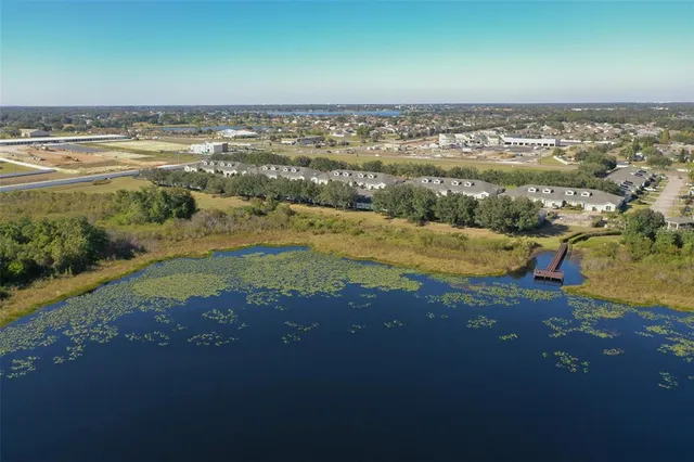 an aerial view of residential houses with outdoor space and ocean view