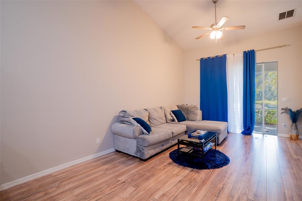 2739 Rutledge Court Winter Haven, FL 33884 - Photo 3 of 24 a living room with furniture and a wooden floor