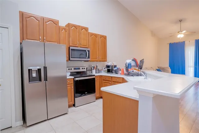 a kitchen with stainless steel appliances a stove microwave and a refrigerator