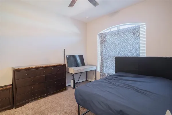 a bedroom with a bed and a dresser