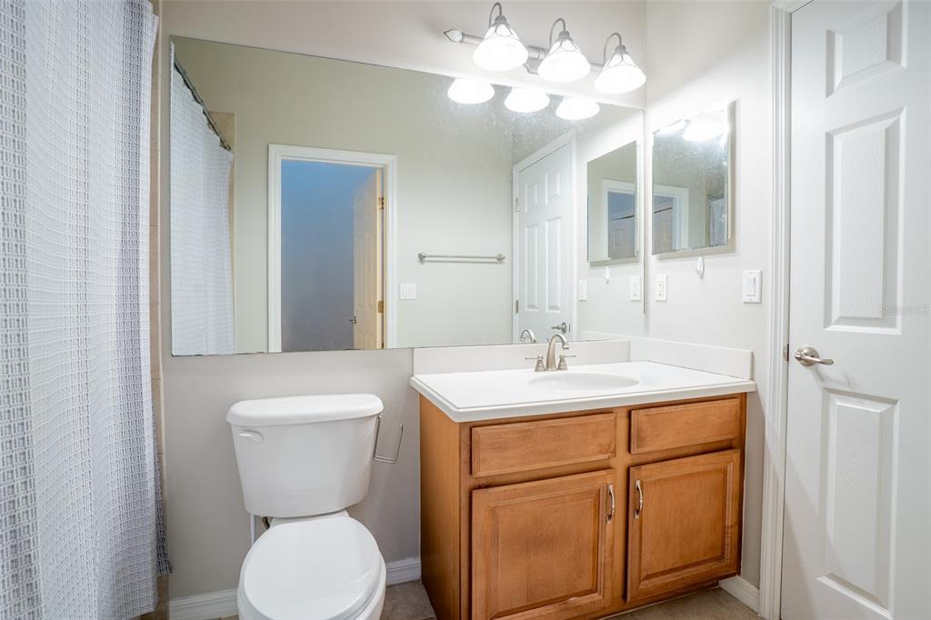 2739 Rutledge Court Winter Haven, FL 33884 - Photo 8 of 24 a bathroom with a toilet sink and mirror