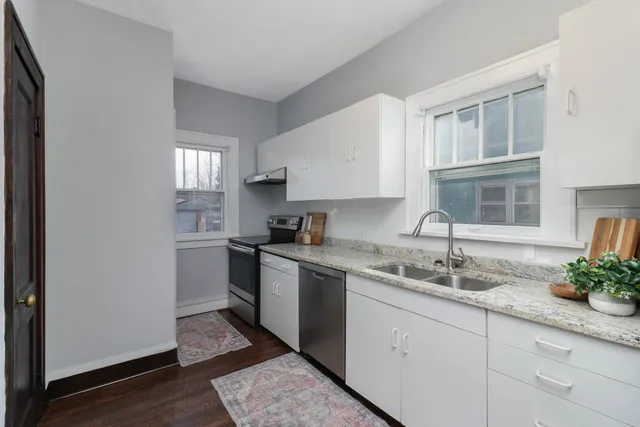 a kitchen with a sink cabinets and window