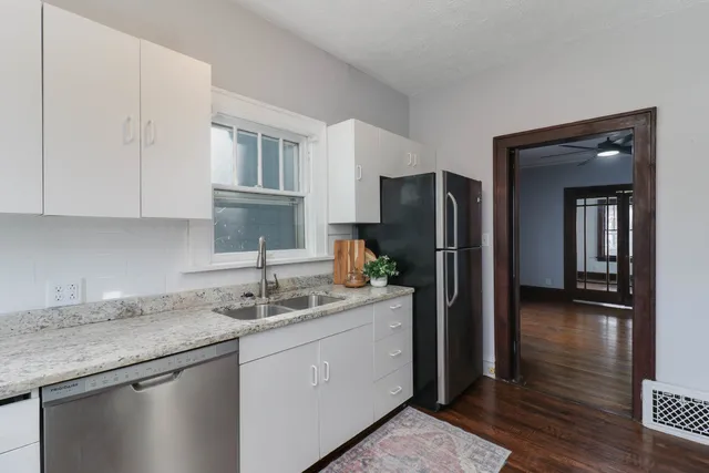 a kitchen with a sink and a refrigerator