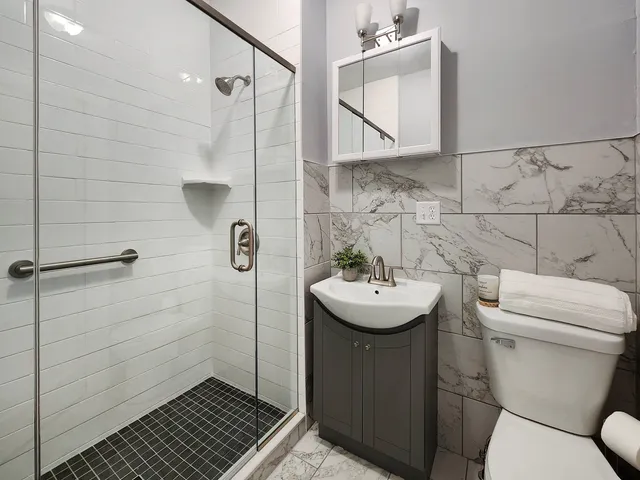 a bathroom with a sink toilet and shower