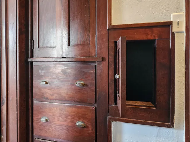 a bathroom with a glass shower door and a window