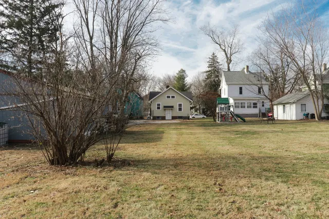 a view of a house with a yard covered with snow