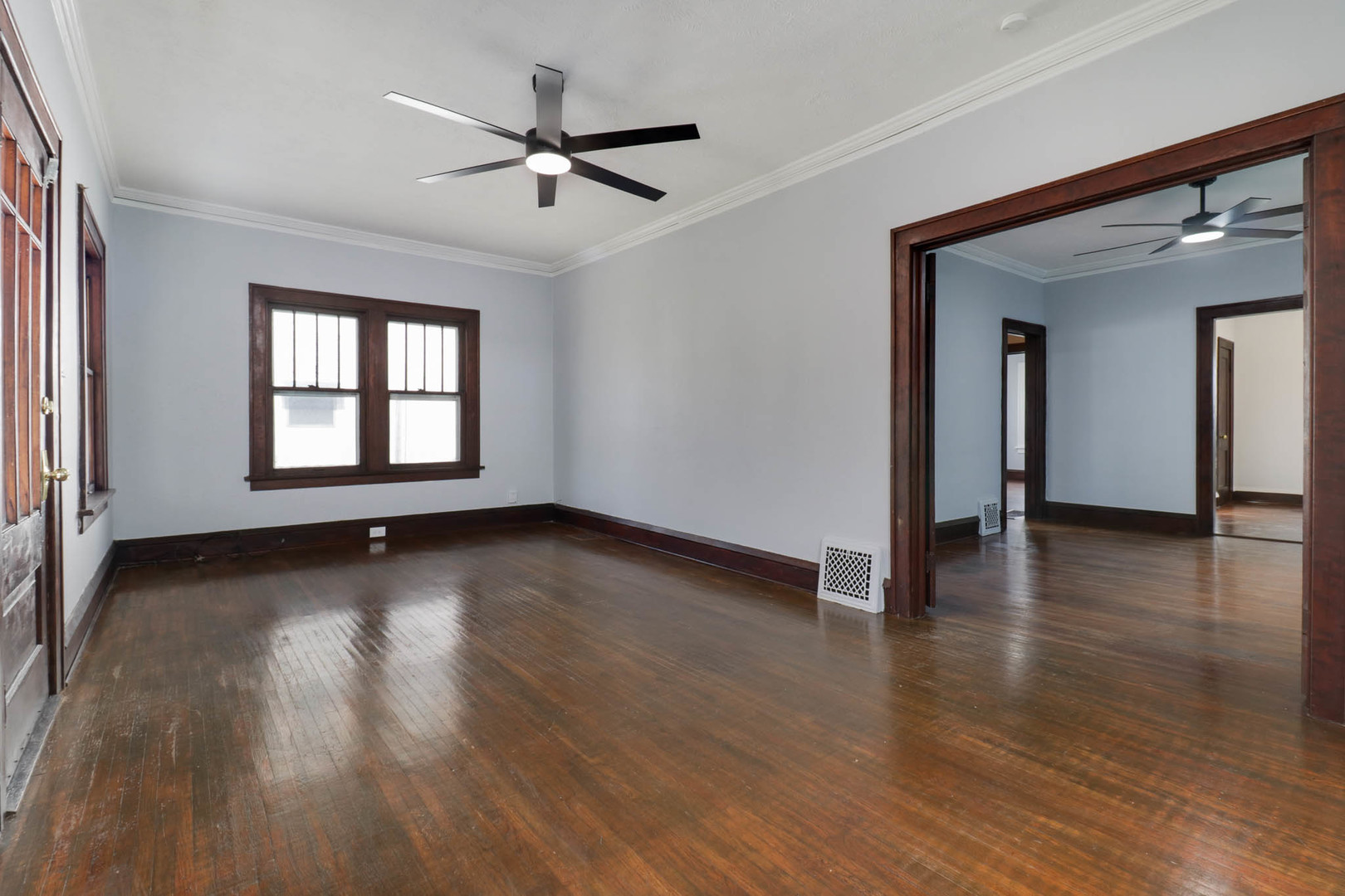 508 North School Street Normal, IL 61761 - Photo 6 of 38 an empty room with wooden floor chandelier and windows