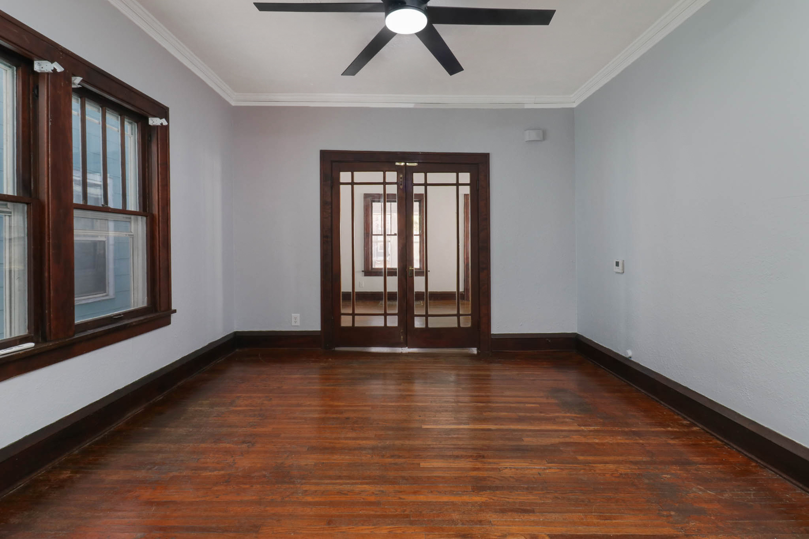 508 North School Street Normal, IL 61761 - Photo 9 of 38 a view of an empty room with wooden floor and a window