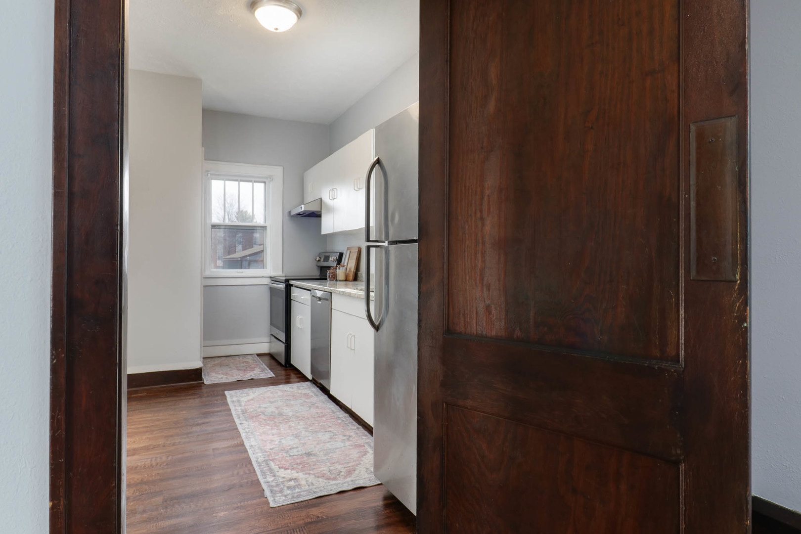 508 North School Street Normal, IL 61761 - Photo 10 of 38 a kitchen with a refrigerator and white cabinets