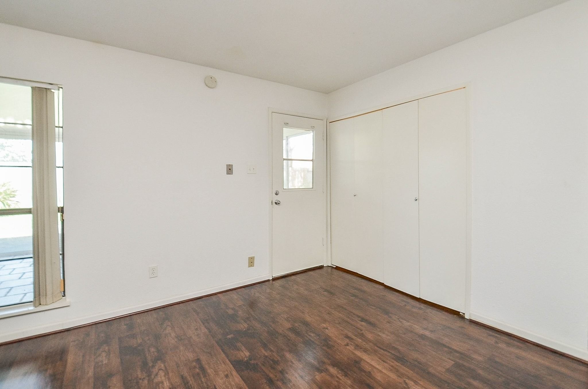 17518 Autumn Trails Lane Houston, TX 77084 - Photo 19 of 30 an empty room with wooden floor and windows