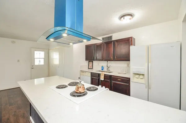 a kitchen with a sink a stove and refrigerator