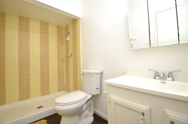 a bathroom with a sink a toilet and shower
