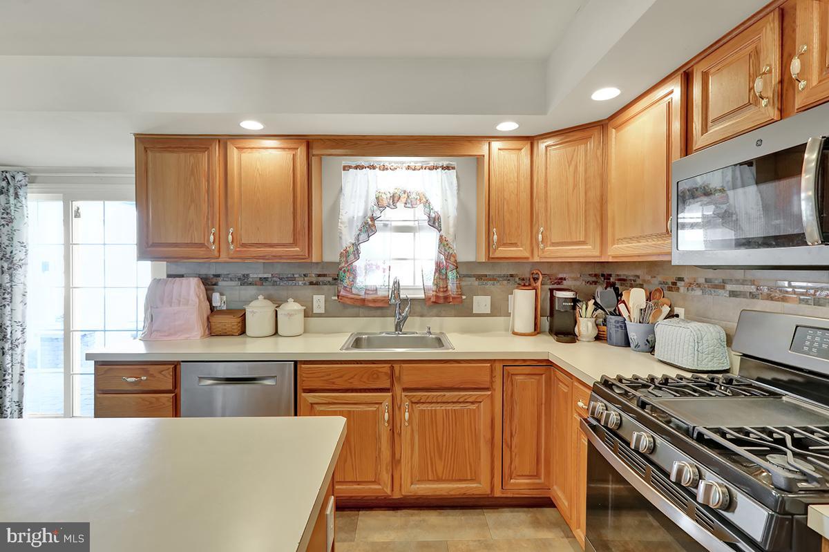 103 Eagles Lane Reading, PA 19608 - Photo 12 of 42 a kitchen with stainless steel appliances granite countertop a stove a sink dishwasher and a refrigerator