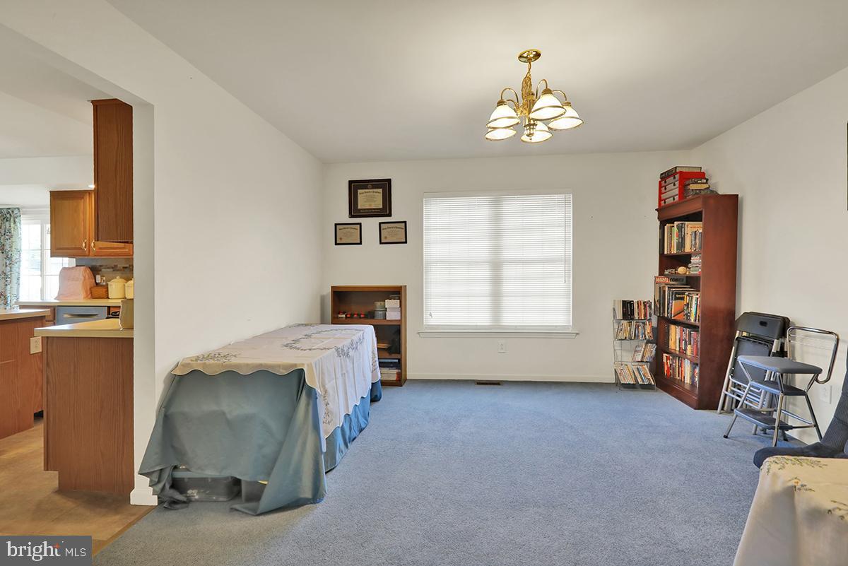 103 Eagles Lane Reading, PA 19608 - Photo 20 of 42 a living room with furniture and a chandelier