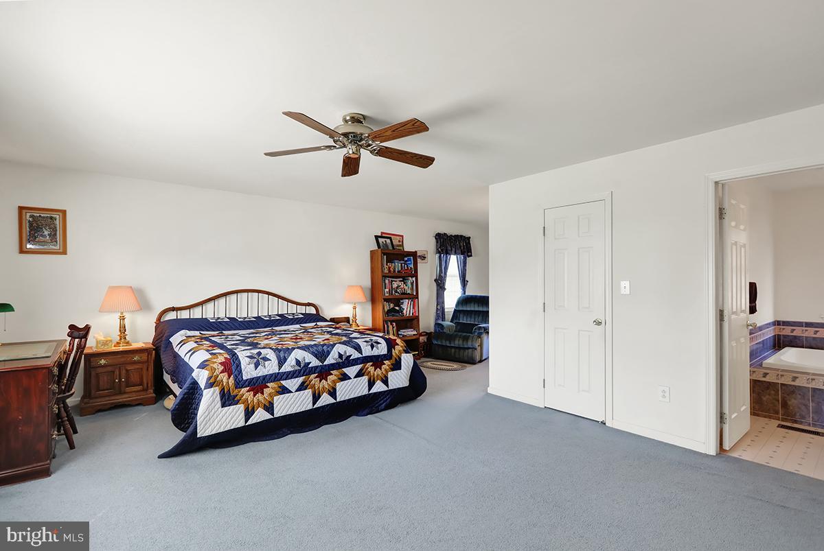 103 Eagles Lane Reading, PA 19608 - Photo 24 of 42 a bedroom with a bed and a chandelier