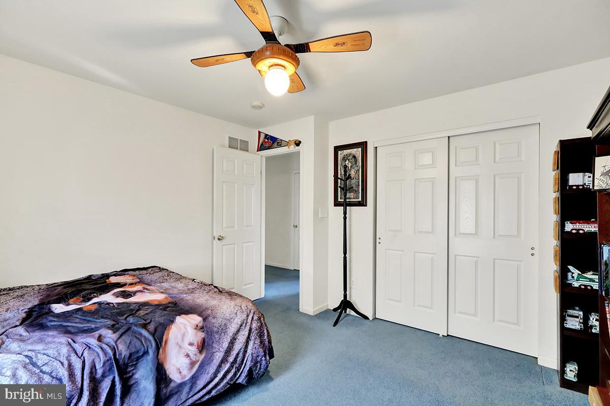 103 Eagles Lane Reading, PA 19608 - Photo 33 of 42 a bedroom with a bed and a chandelier