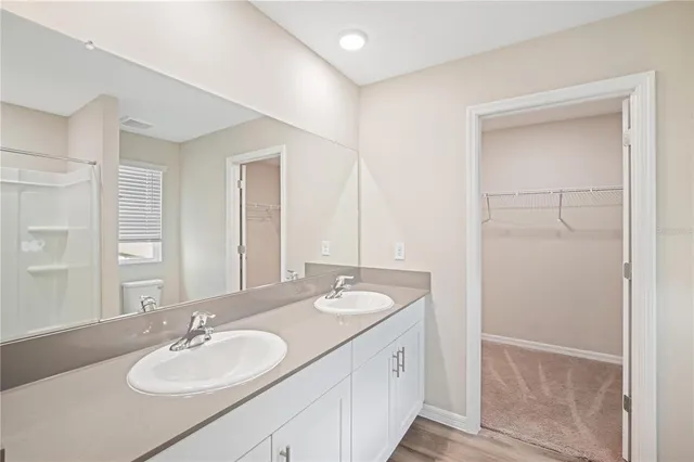 a bathroom with 2 sink and a mirror