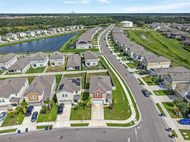 an aerial view of residential houses with outdoor space and swimming pool